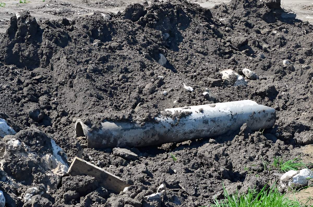 Exposed broken pipe lying in a patch of disturbed soil, showing a common landscaping mistake in Las Vegas.