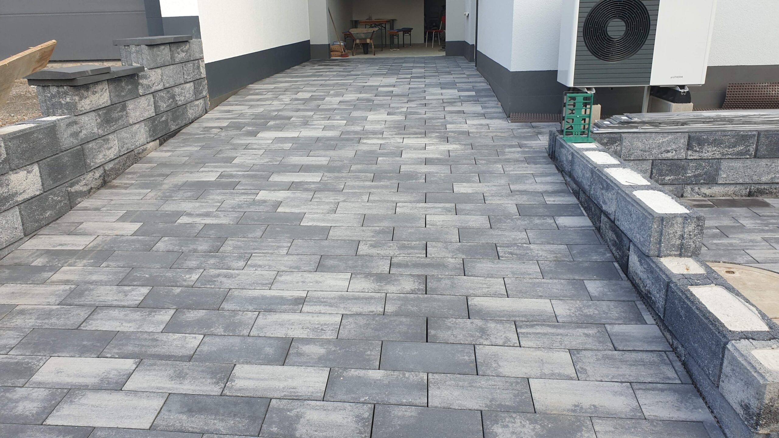 Modern gray paver driveway installation by Sun Valley Landscaping in Las Vegas featuring durable interlocking stones.