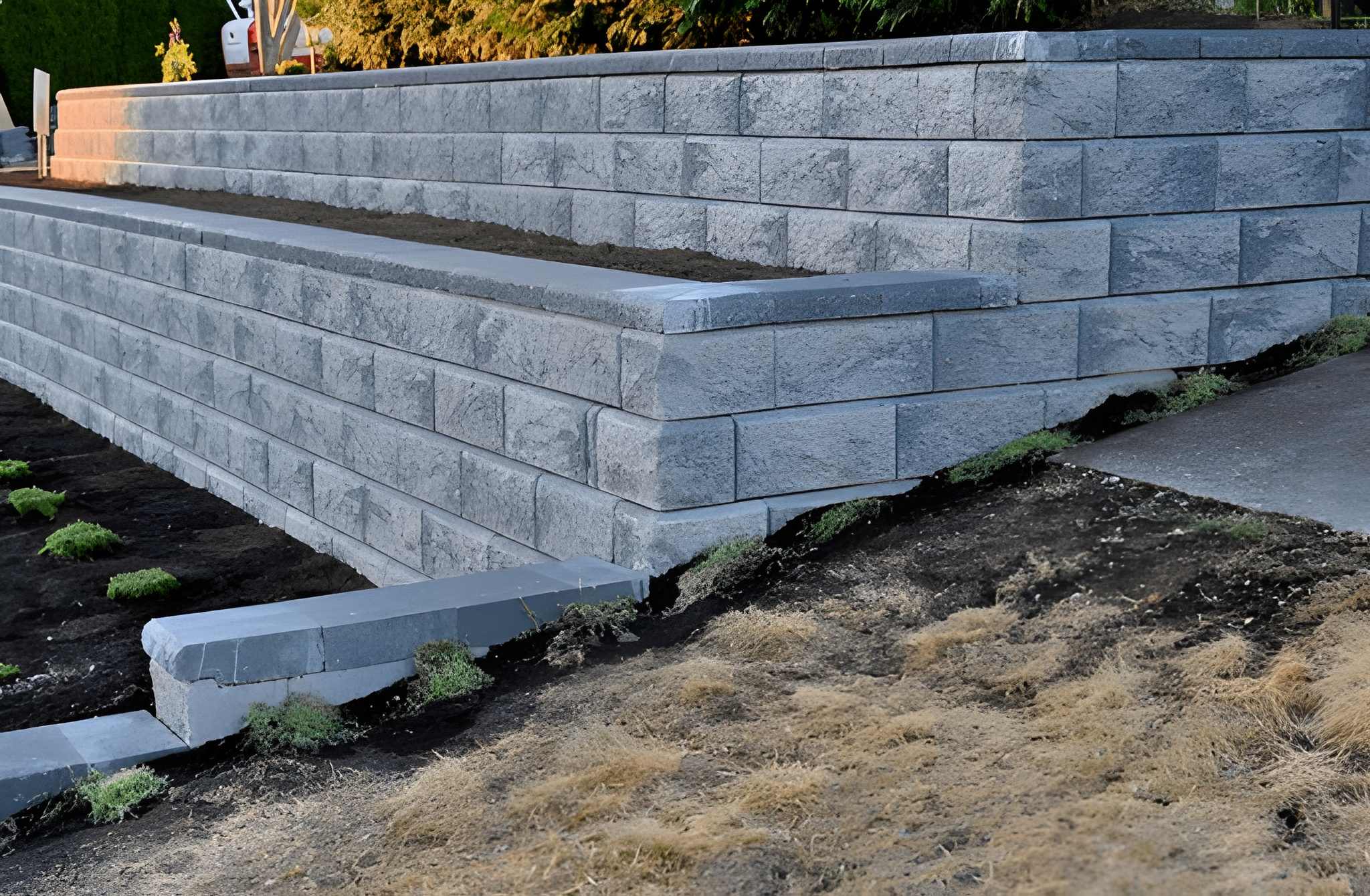 Hardscaping Henderson Curb Appeal Upgrades for Front Yard Design-2 Stone retaining wall with layered steps and plants, built by Sun Valley Landscaping to elevate outdoor spaces and improve yard structure.
