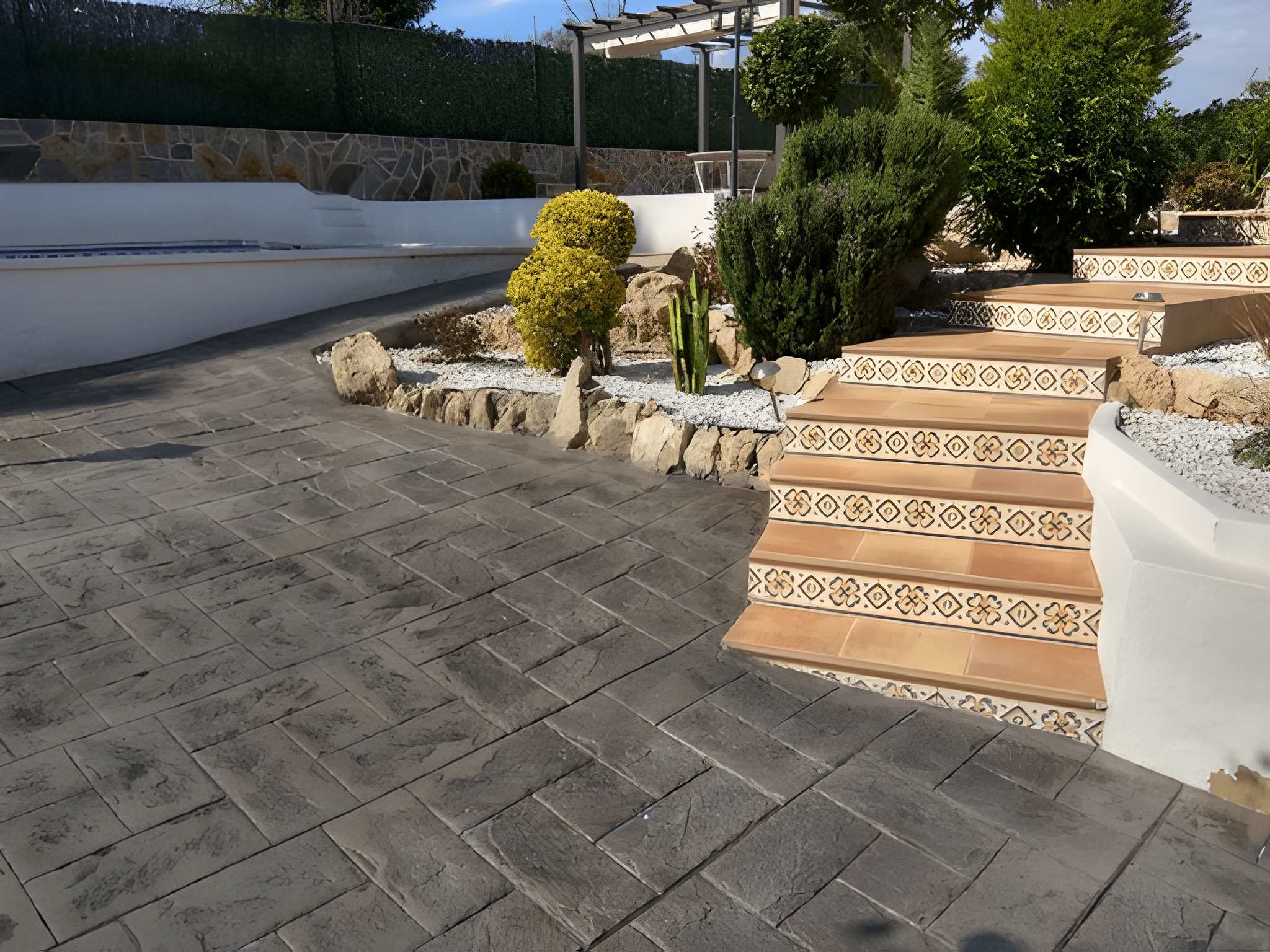 Low Maintenance Landscaping Las Vegas Ideas for the New Year-5 Sun Valley Landscaping's beautifully designed outdoor space with tiled steps, pavers, and lush greenery, perfect for a low maintenance landscape.